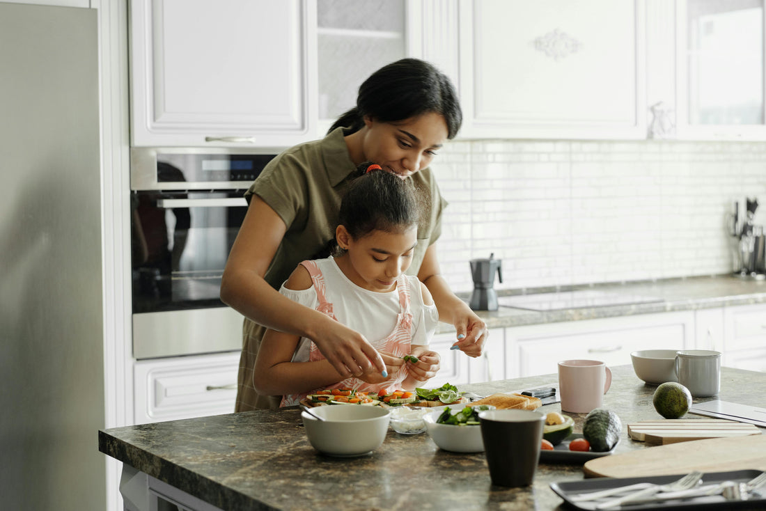 A woman and her child prepare a healthy meal together