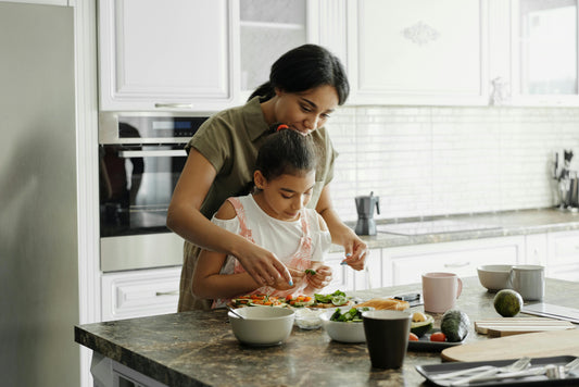 A woman and her child prepare a healthy meal together